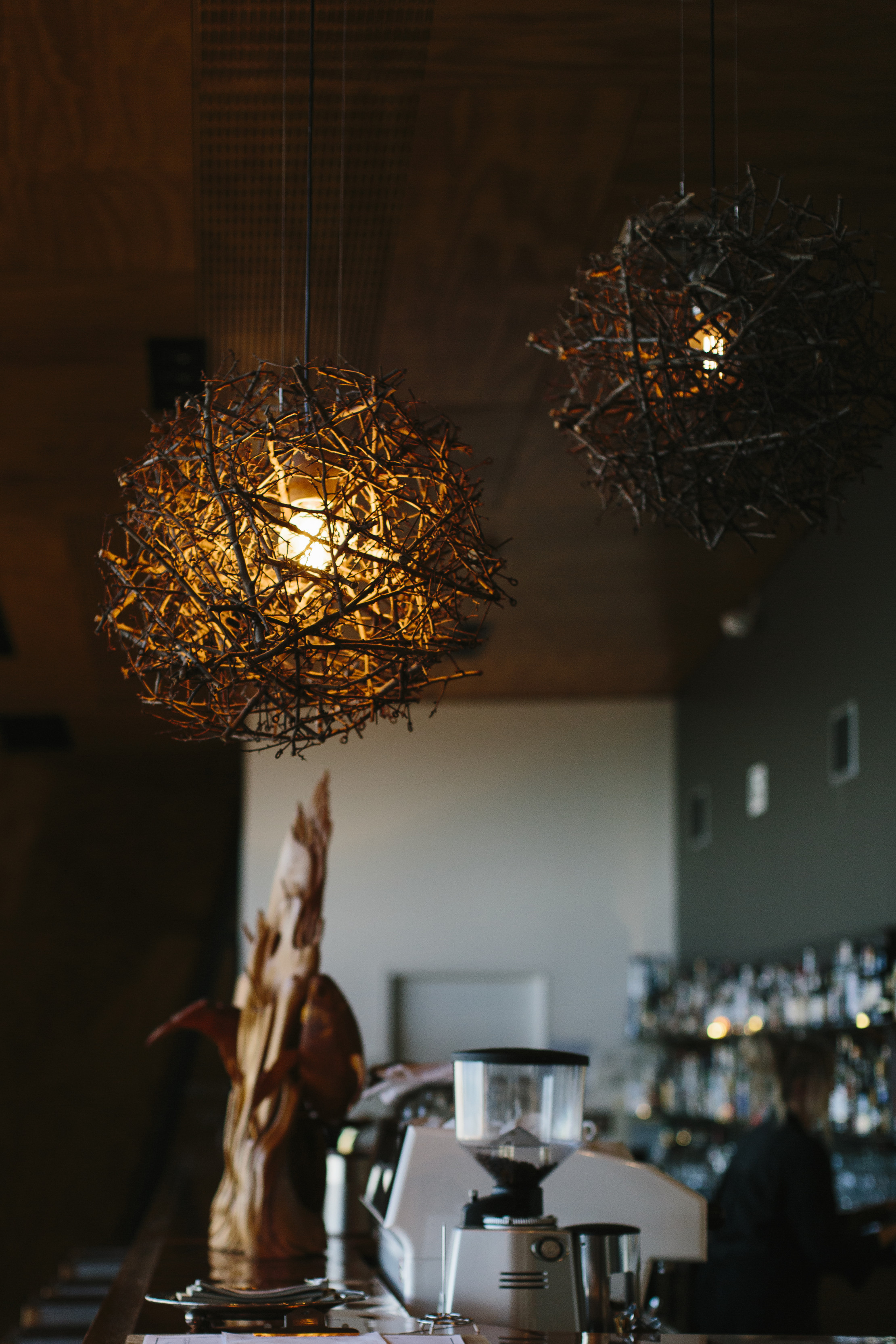 Image of rustic lights and bar at Mrs Jones restaurant bar lounge, located beachside at the Bluff on the second level above the Devonport Surf Club.
