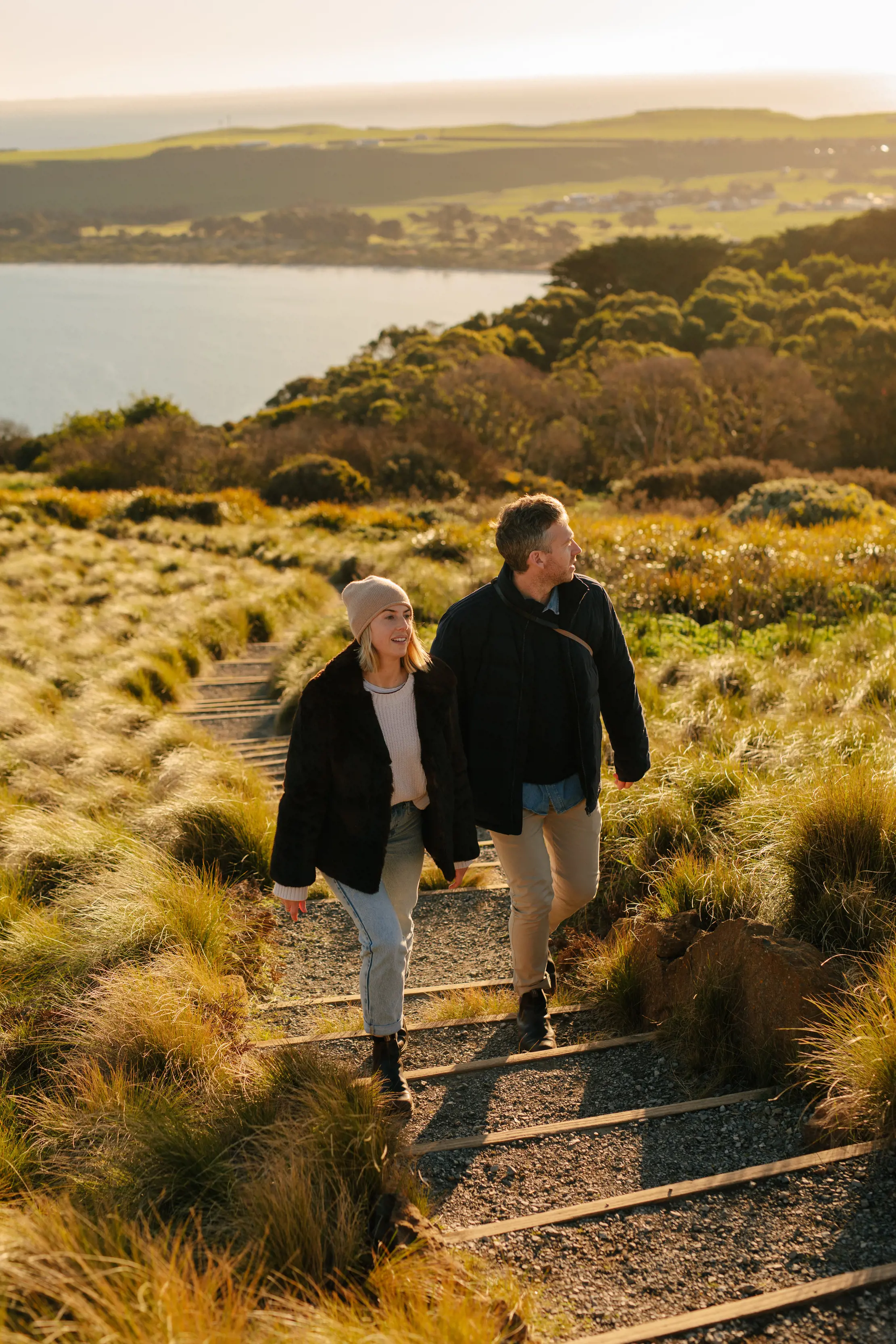 A couple walks along a track on The Nut on a warm, sunny morning.