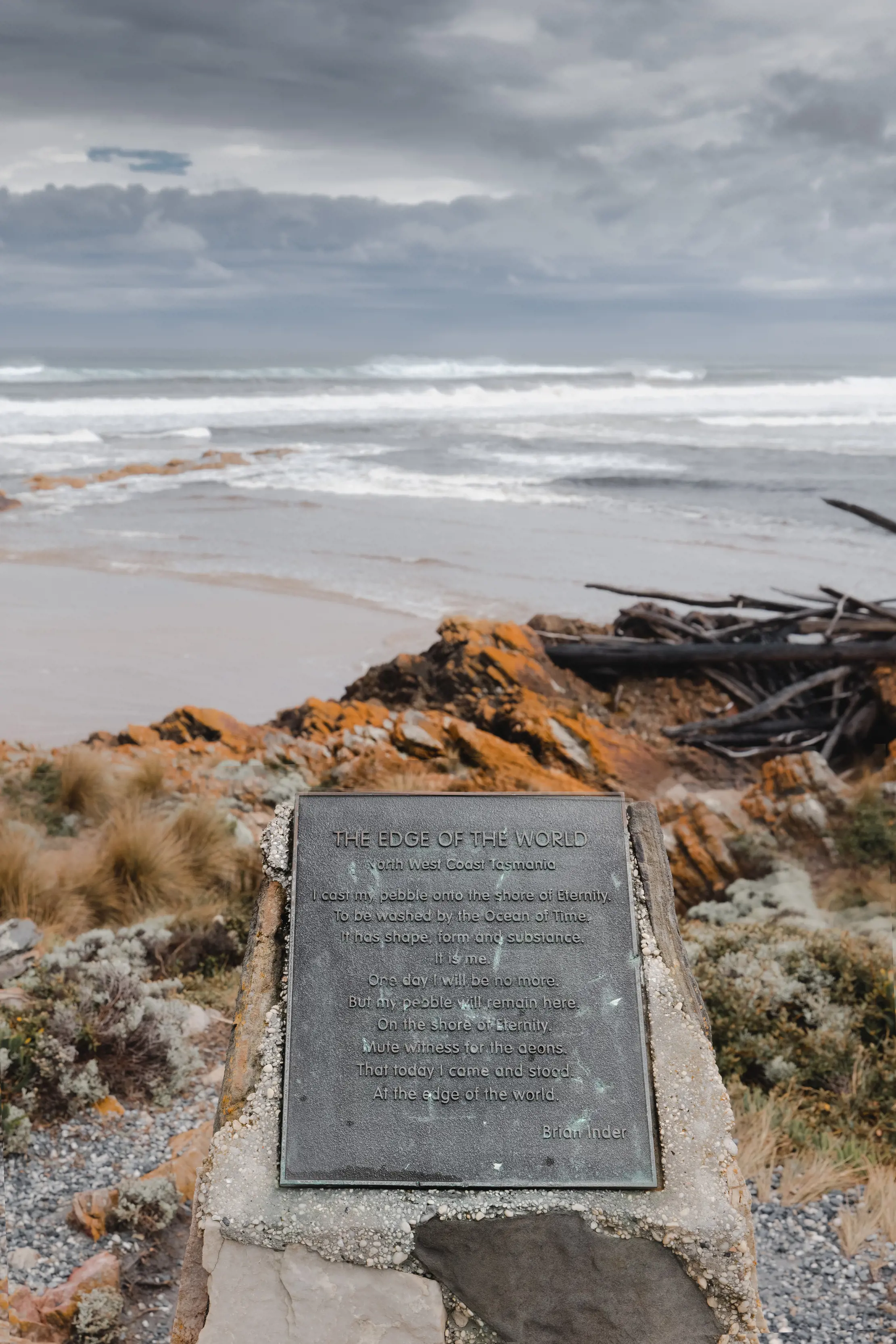 A plaque labelling "Edge of the World" in the bottom centre of the image with the ocean in the background.