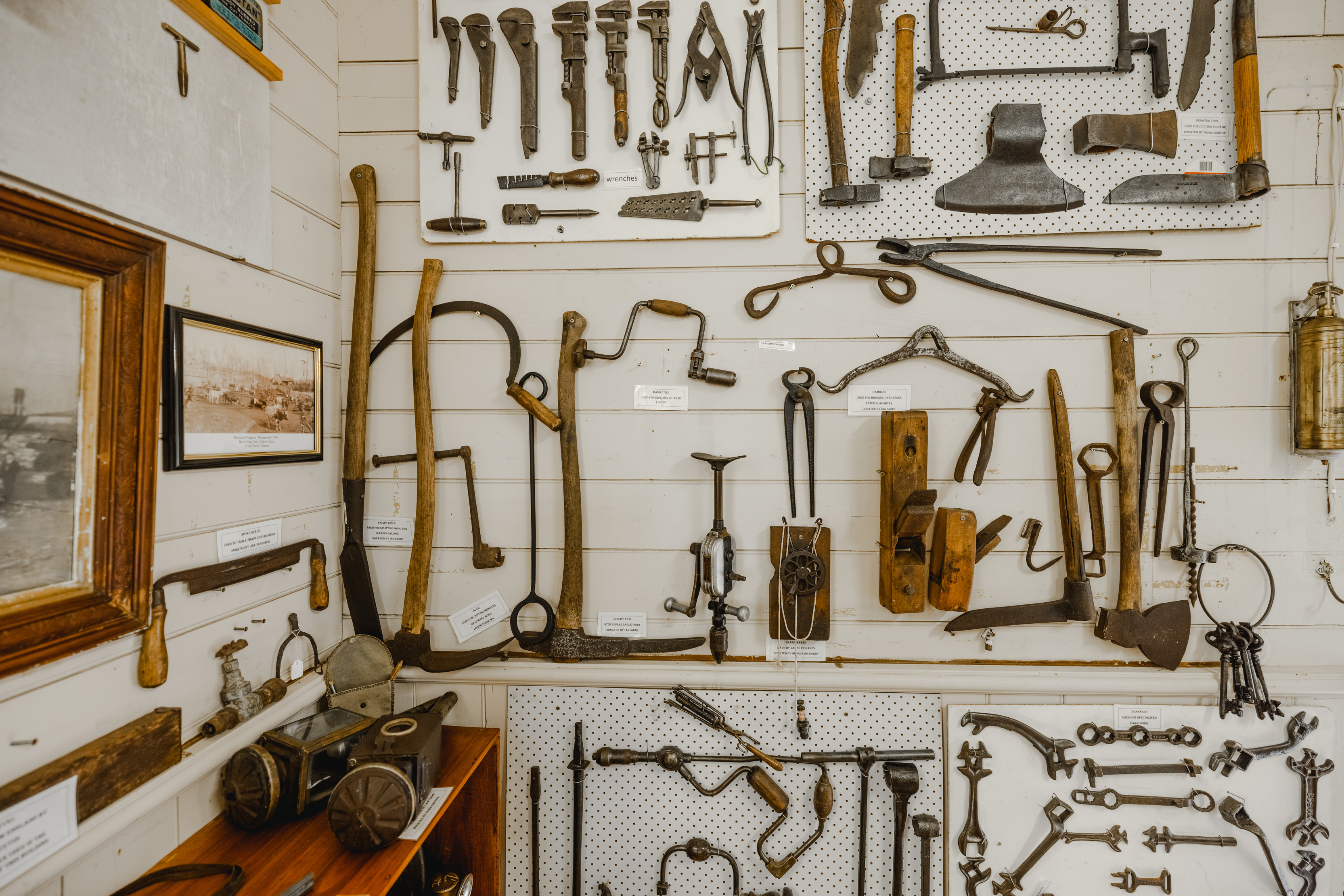 Image within the Wilmost Museum. Antique tools fill the wall.