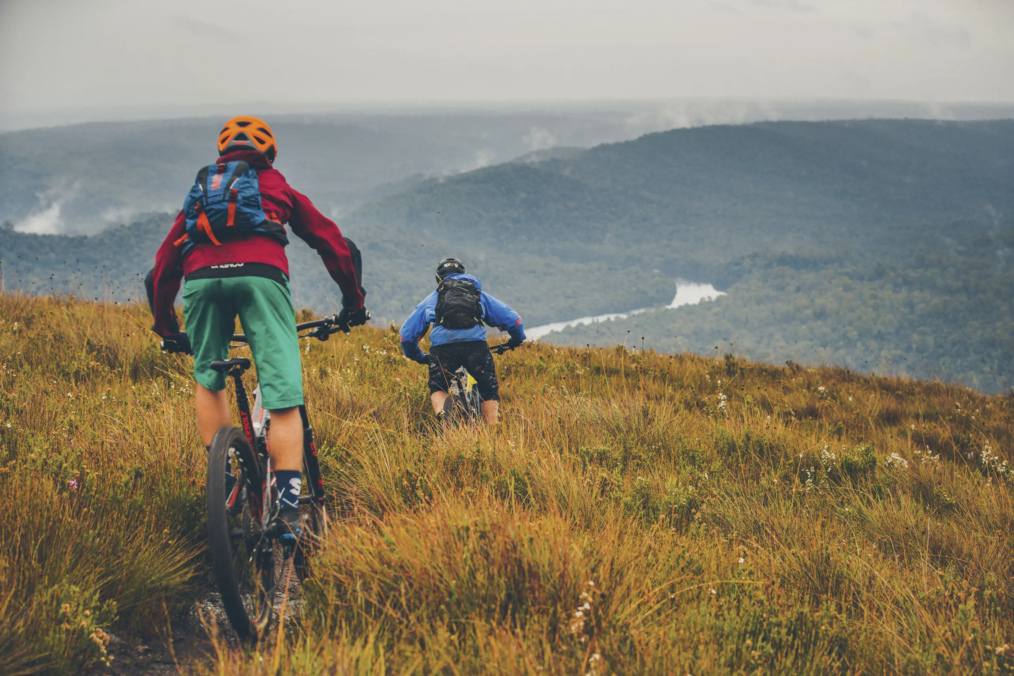 Two bike riders travel along the Mt Donaldson Track, takayna / Tarkine.