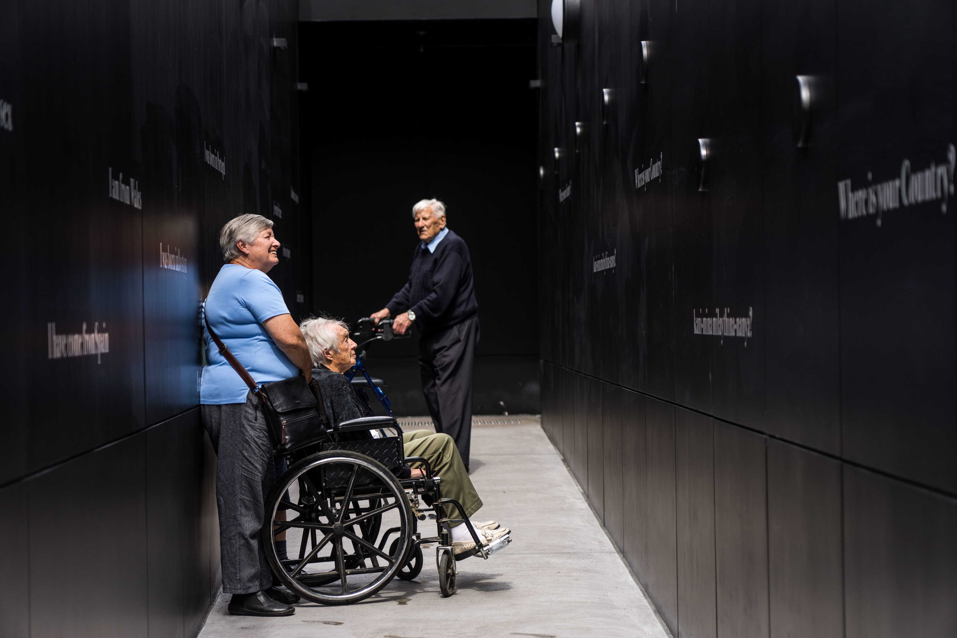 An elderly couple, one being in a wheelchair, exploring the Cascade Female Factory Historic Site.