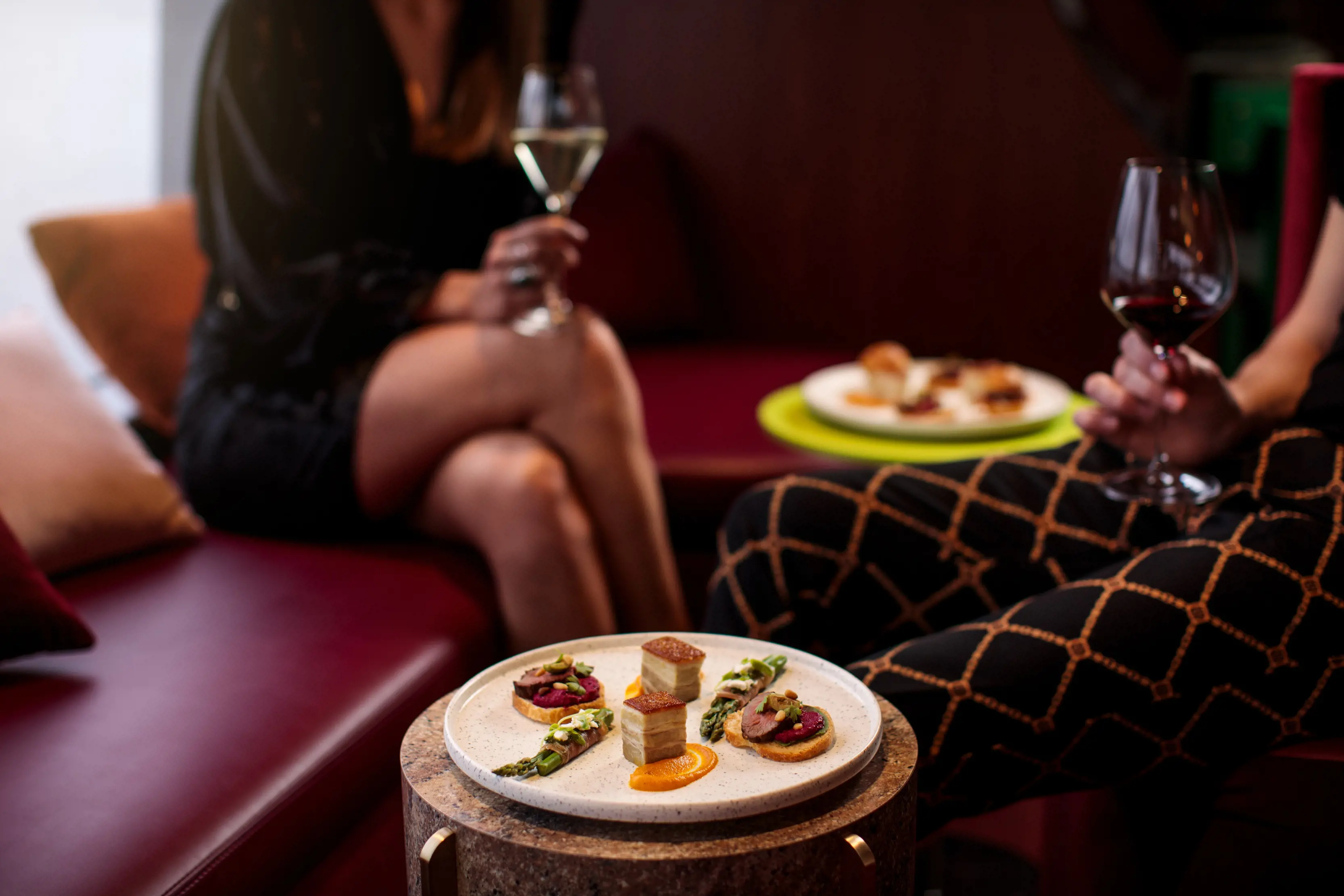 Image of two people drinking wine with divine food on a platter within the Mona Roma ferry MR-II, Posh Pit.