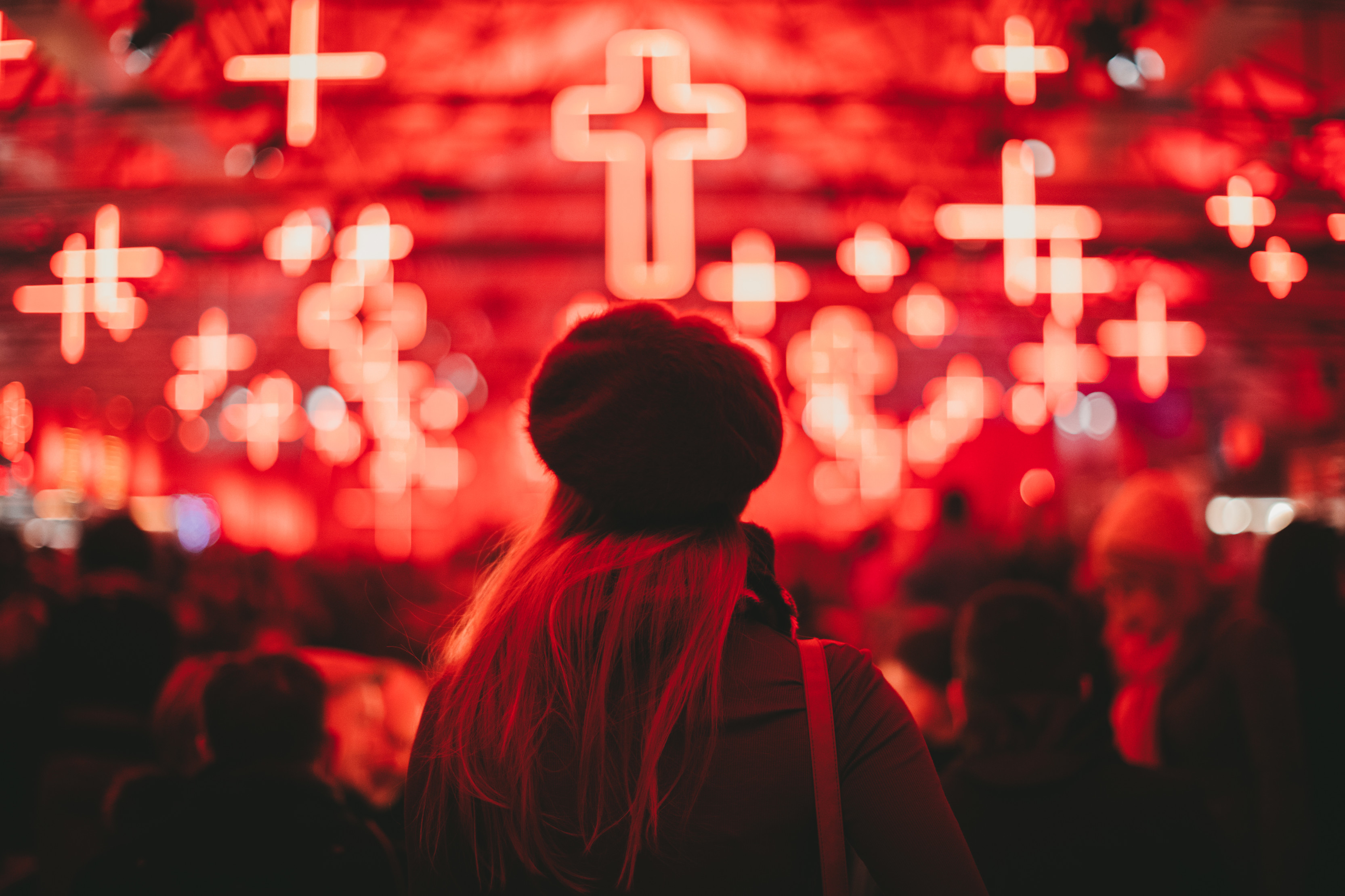 Image of people standing in front of red crosses at Dark Mofo, winter Feast
