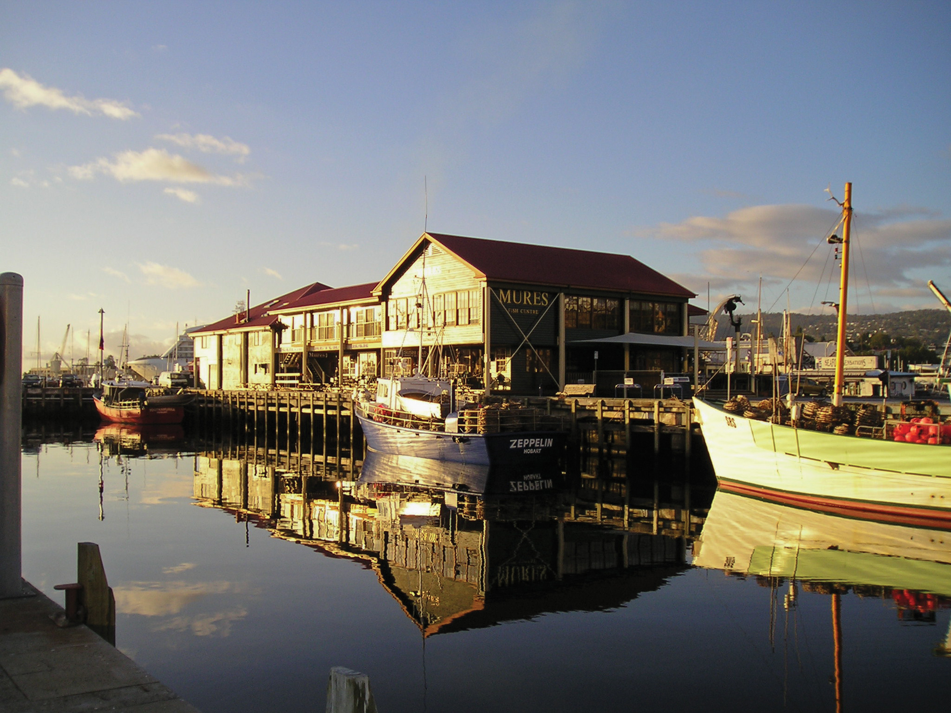 Sun setting over the charming Mures Fish Centre and Restaurant, calm water surrounds it, apart of the Victoria Dock, Hobart. 
