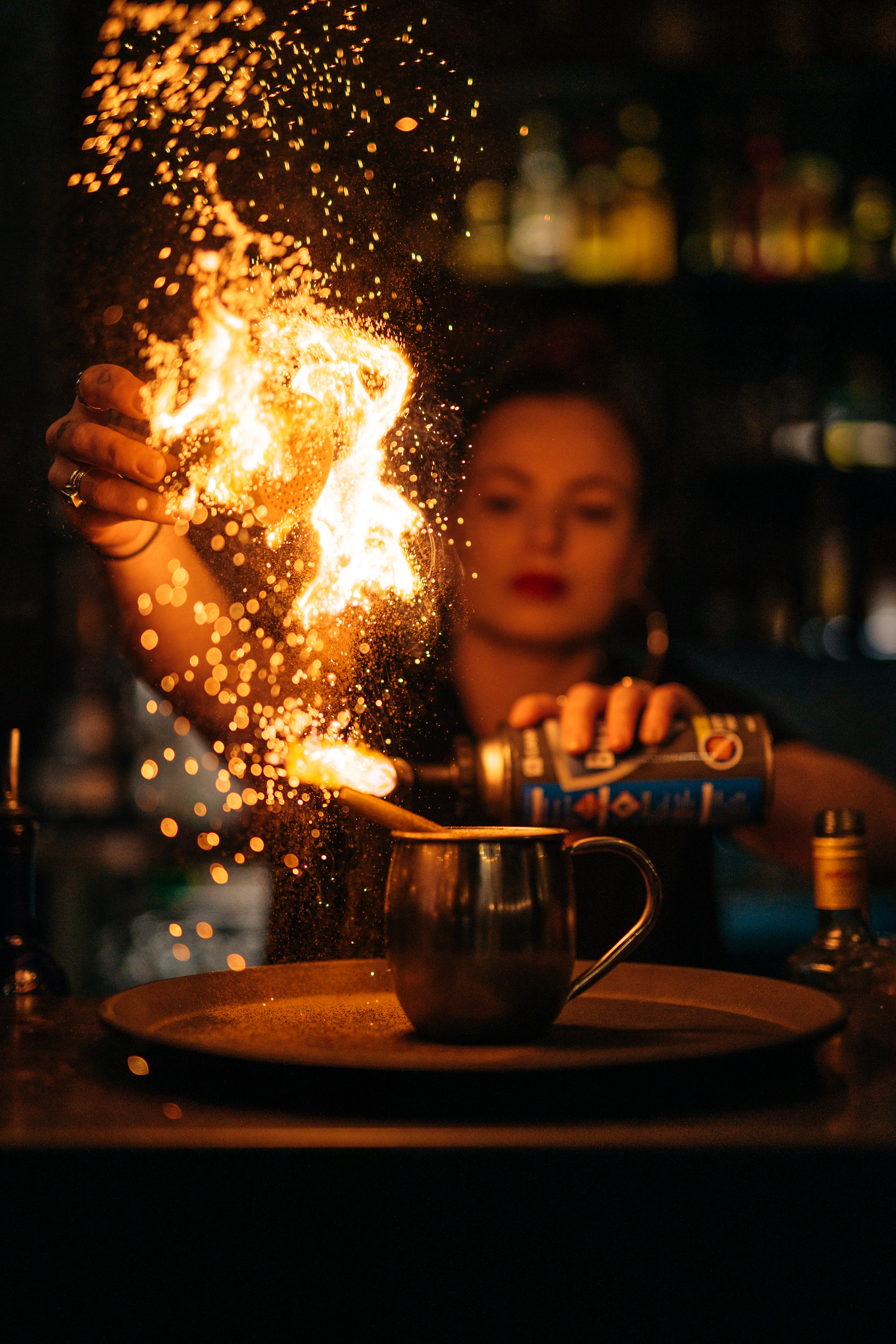 Bartender creating an exciting and unique cocktail with flames and sparks coming out of the cocktail at the Pancho Villa Restaurant and Bar.
