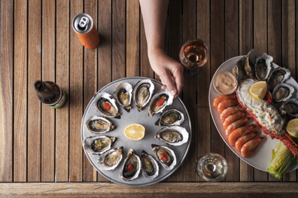 A platter of fresh oysters and other seafood presented on a platter.
