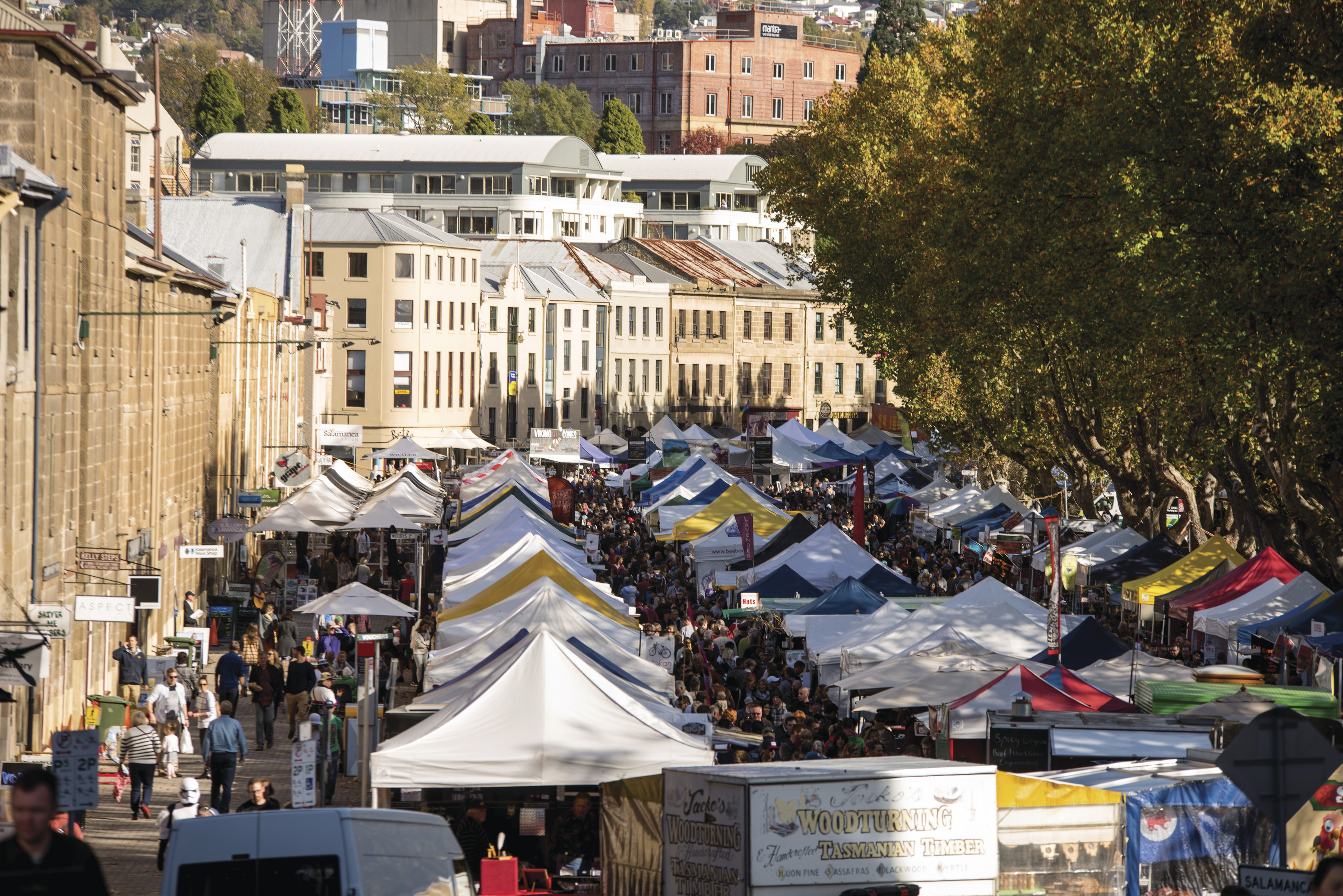 The busy stalls at Salamanca Market. The market is set among the historic Georgian sandstone buildings of Salamanca Place in Hobart.