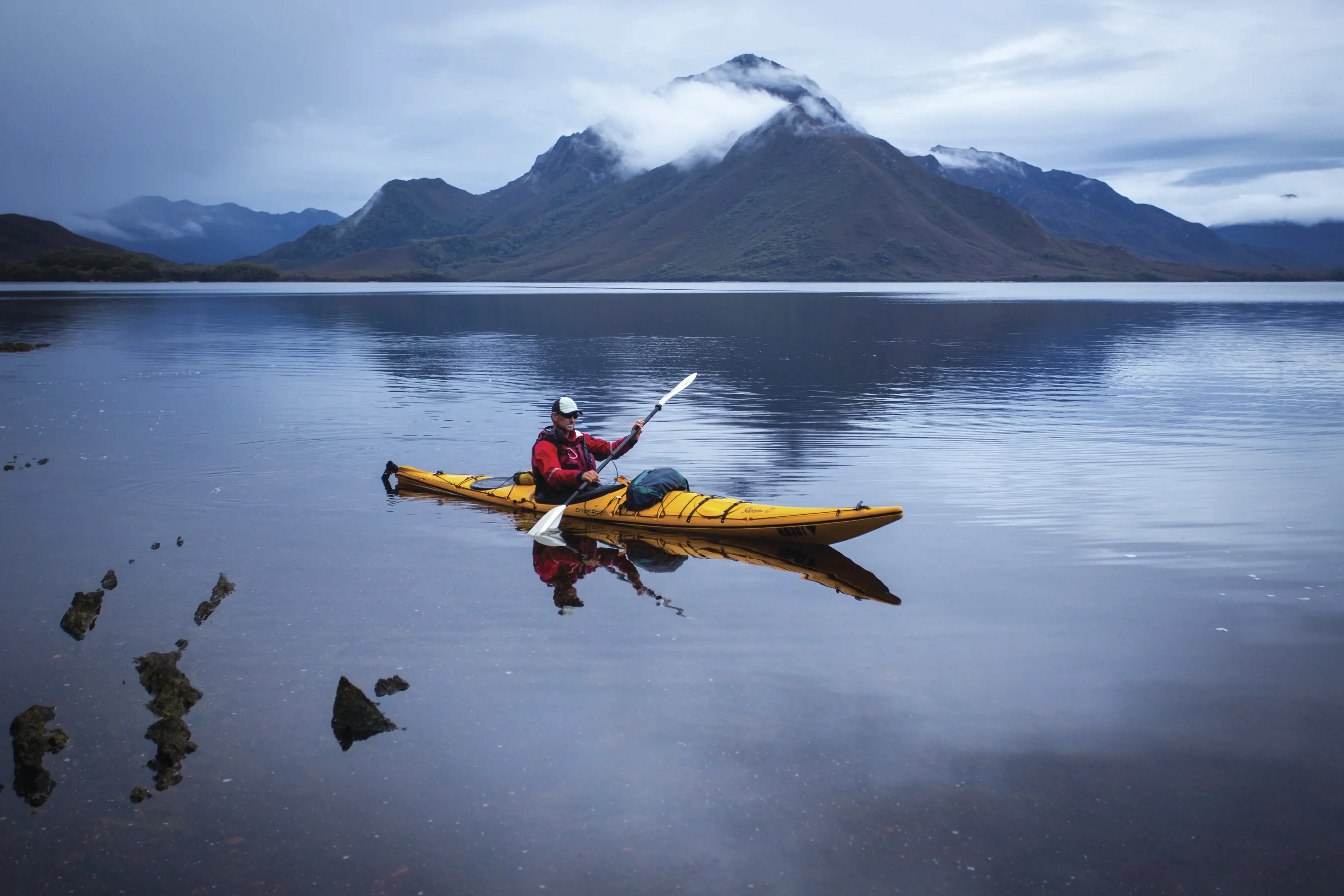 Man in single kayak experiencing the Roaring 40's Ocean Kayaking sea kayaking eco-tour around the Turrakana / Tasman Peninsula.