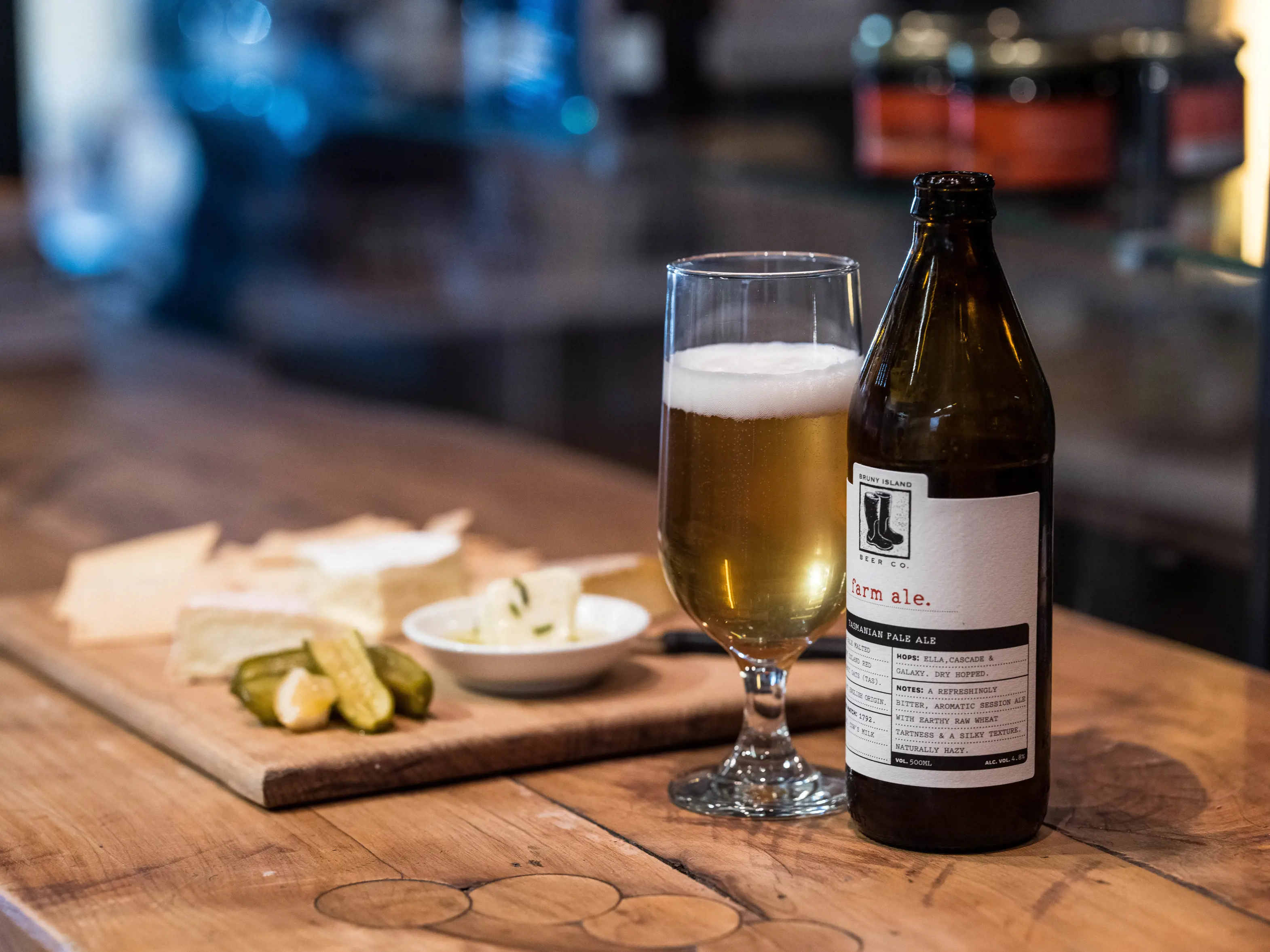 Close up image of a cheese platter and a beverage in the Bruny Island Cheese Co.