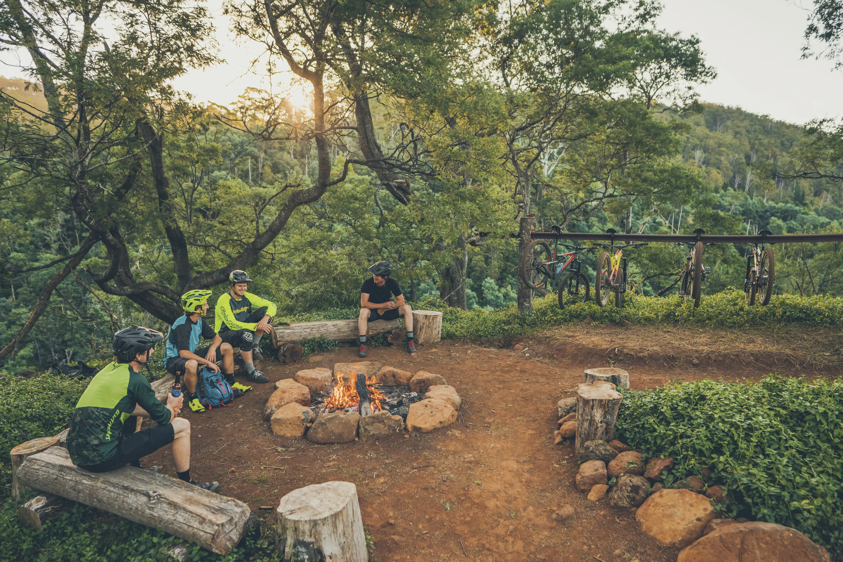 Four bike riders taking a break and sitting around a fire at Sawtooth Lookout, with Blue Derby Mountain Bike Trails.